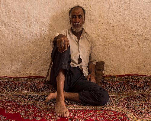 Elderly woman gardening gently in a warm home background